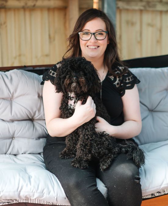 Leanne Woff holding black puppy